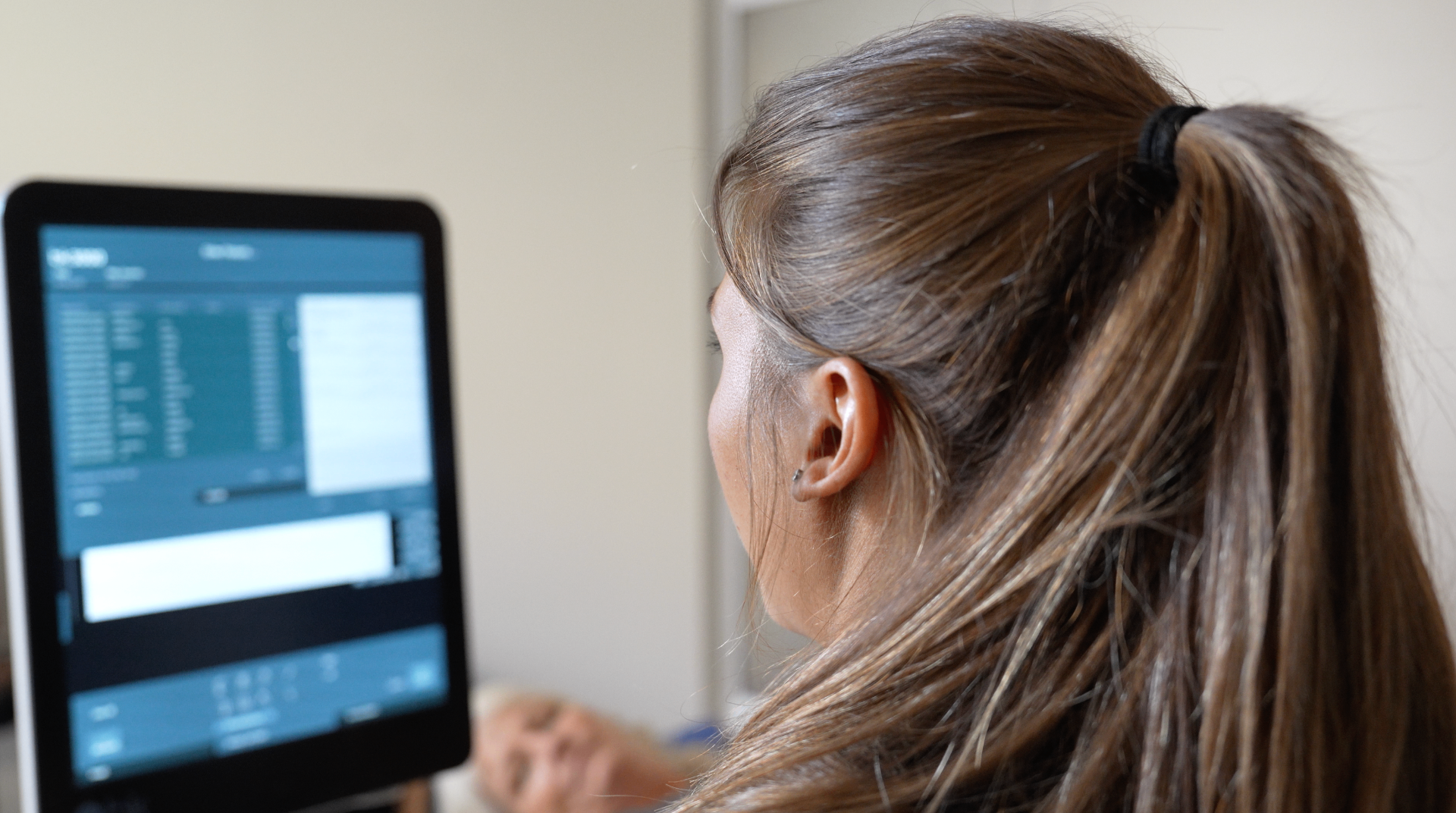 Clinician reviewing patient health data on screen