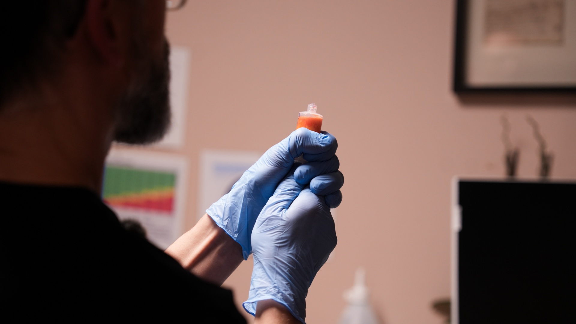 Practitioner examining PRP sample in clinical setting